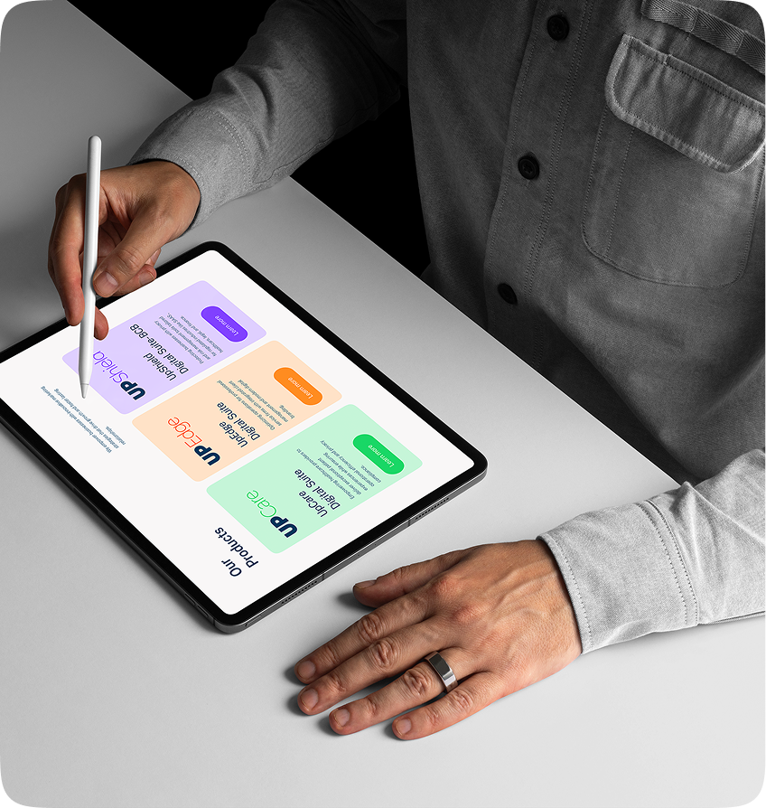 A person using a tablet to navigate the Uprank Technologies website, viewing managed services.